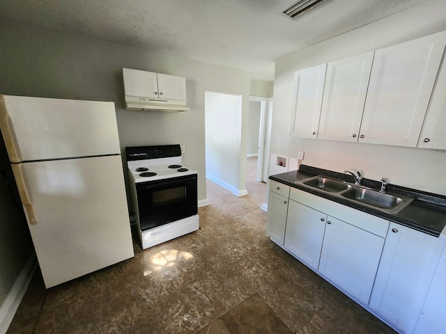 kitchen featuring white refrigerator, white cabinetry, and electric range oven