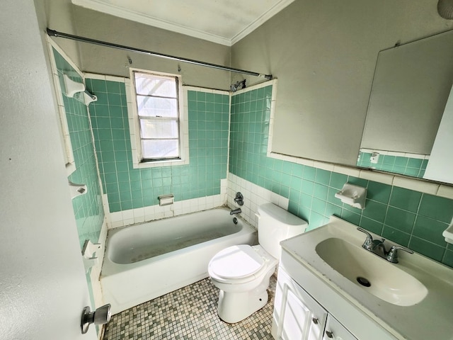 full bathroom featuring toilet, tile walls, ornamental molding, vanity, and tiled shower / bath combo