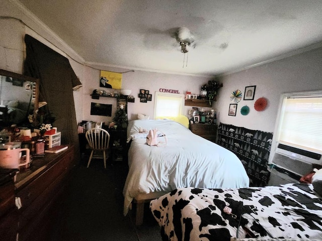 bedroom featuring ceiling fan, ornamental molding, and multiple windows