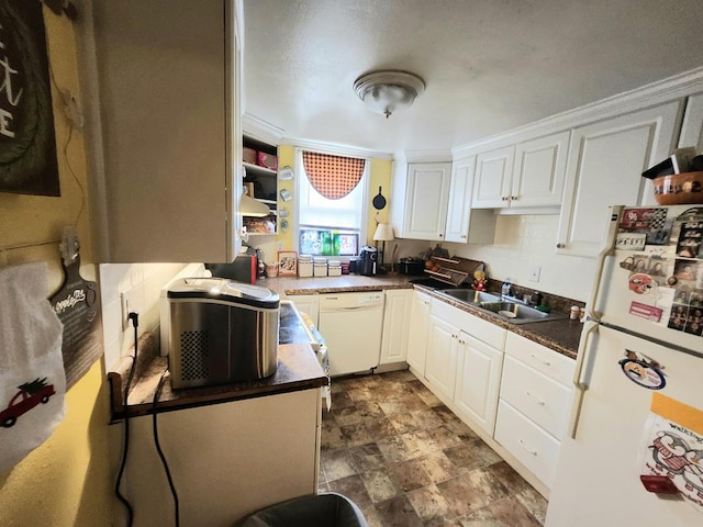 kitchen with white cabinetry, white appliances, and sink