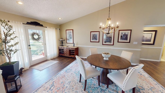 dining space with dark wood-type flooring, a chandelier, lofted ceiling, recessed lighting, and a textured ceiling