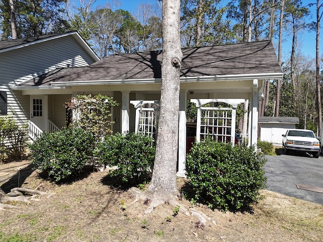 exterior space featuring a shingled roof