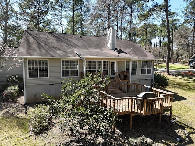 rear view of house with crawl space, stairway, a chimney, and a wooden deck