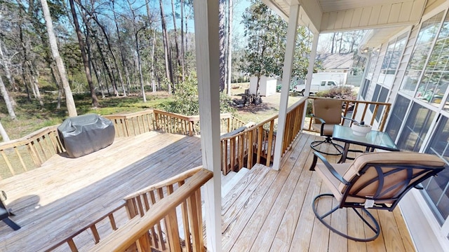 wooden terrace featuring a grill