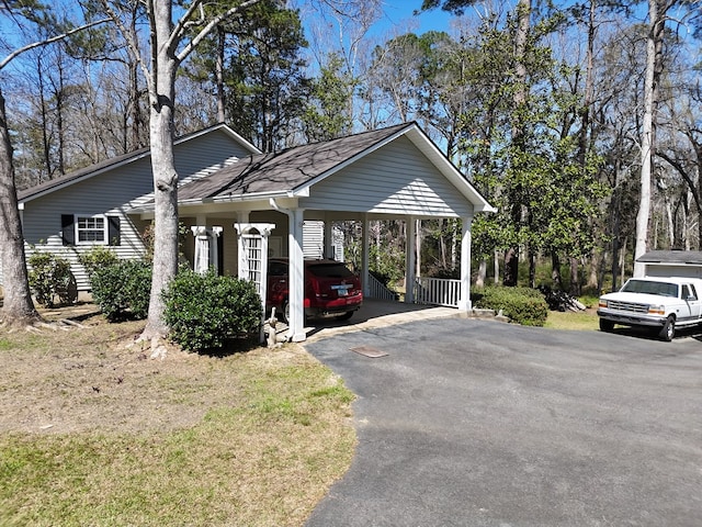 view of car parking featuring aphalt driveway