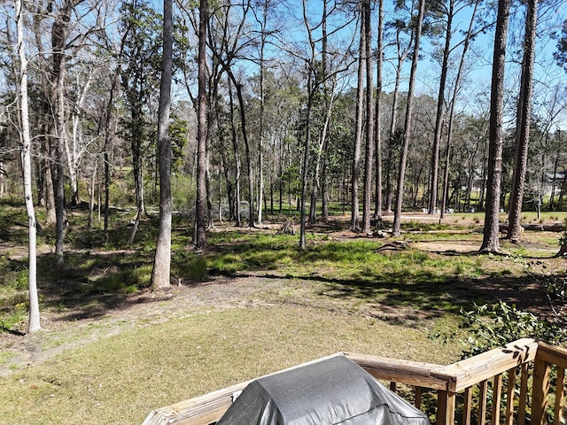 view of yard featuring a forest view