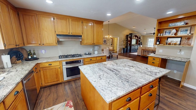 kitchen featuring light stone countertops, dark wood finished floors, stainless steel appliances, vaulted ceiling, and under cabinet range hood