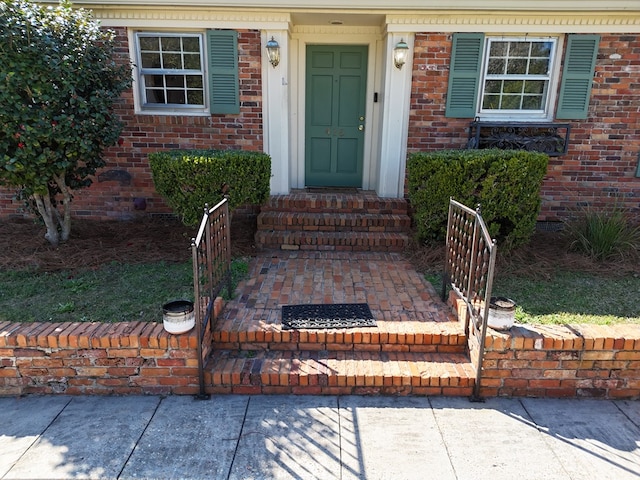 property entrance featuring brick siding