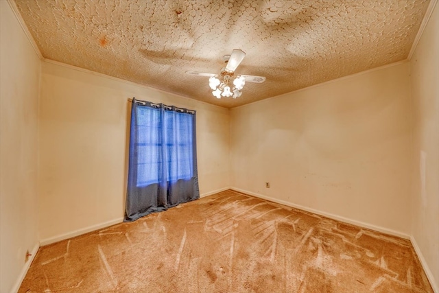 carpeted empty room featuring ceiling fan, ornamental molding, and a textured ceiling