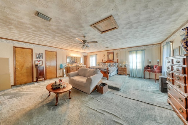 carpeted bedroom featuring ceiling fan, ornamental molding, and a textured ceiling