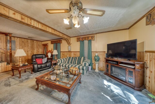 carpeted living room featuring crown molding, a textured ceiling, and wood walls