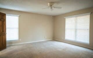 carpeted empty room with ceiling fan