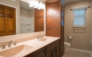 bathroom featuring tile patterned flooring, vanity, and toilet