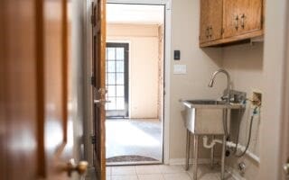 laundry area with cabinets and light tile patterned flooring