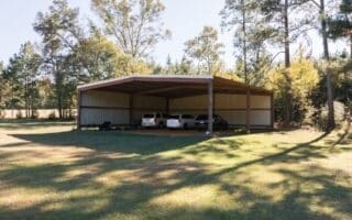 view of parking with a carport and a lawn