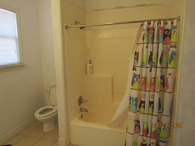 bathroom with shower / tub combo, tile patterned floors, and toilet