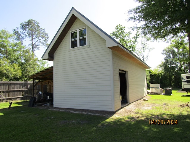 rear view of house with a yard and central AC unit