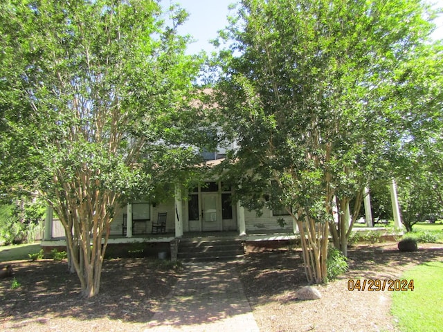 obstructed view of property with a porch