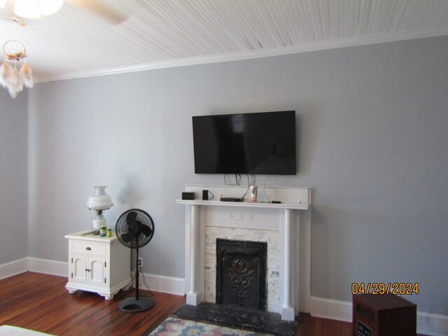 living room featuring dark wood-type flooring and ornamental molding