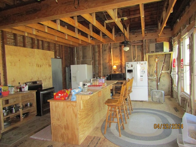 kitchen with stainless steel electric range, plenty of natural light, and white fridge with ice dispenser