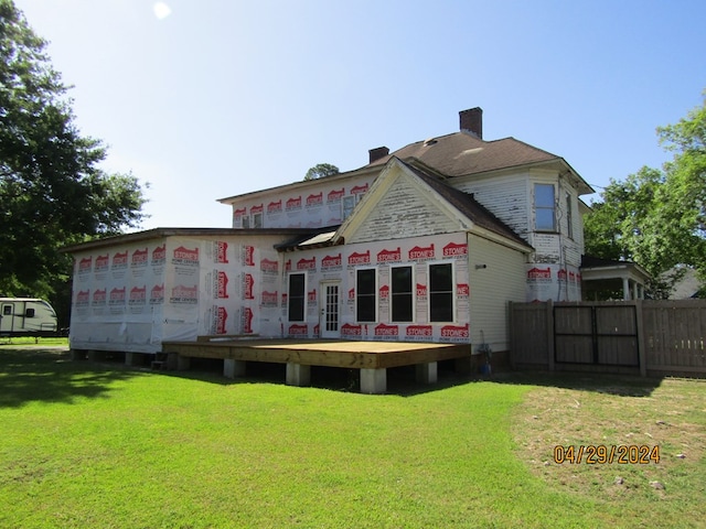 back of house with a yard and a deck