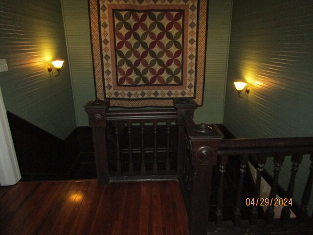 staircase with hardwood / wood-style floors