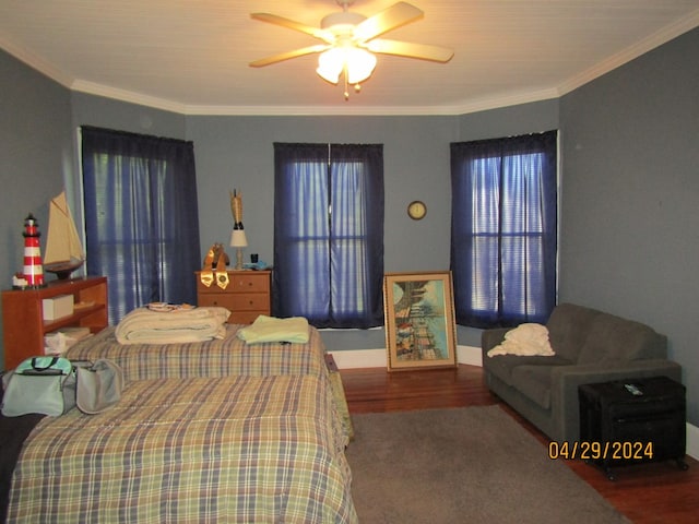 bedroom featuring crown molding, wood-type flooring, and ceiling fan