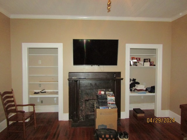 living room with dark wood-type flooring, crown molding, and built in features