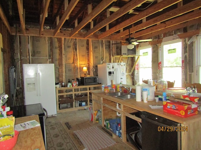 kitchen with white refrigerator with ice dispenser, sink, and ceiling fan