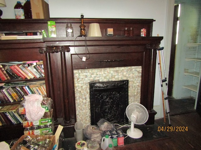 interior details featuring a tile fireplace