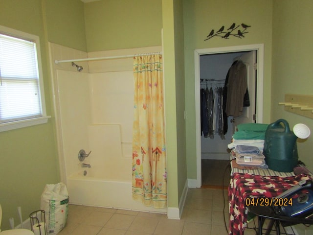 bathroom with shower / bathtub combination with curtain and tile patterned flooring