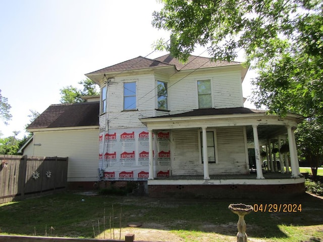 rear view of property with a porch