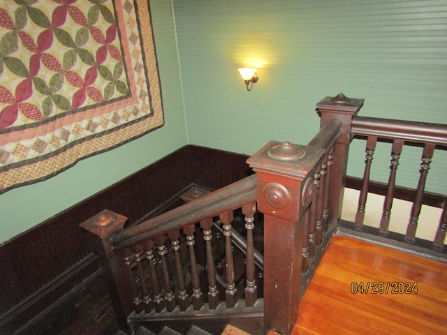 stairway with hardwood / wood-style floors