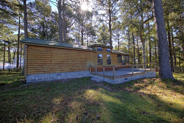 rear view of house featuring a lawn