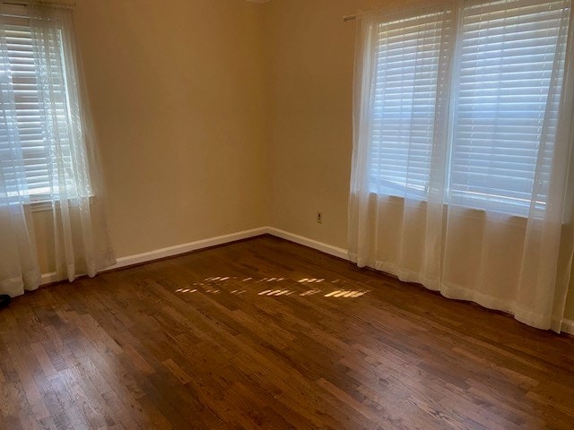 unfurnished room featuring dark wood-type flooring