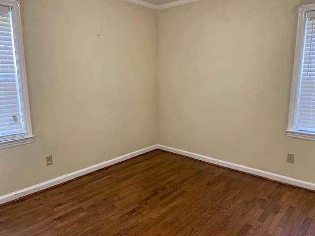 spare room with hardwood / wood-style flooring and ornamental molding