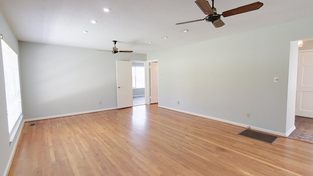 empty room with light wood-style flooring, baseboards, and ceiling fan