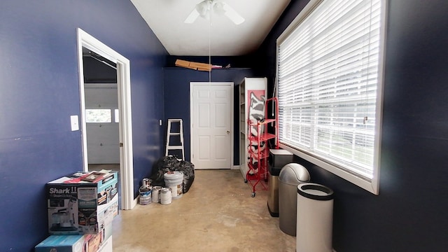 interior space featuring plenty of natural light, concrete flooring, and ceiling fan