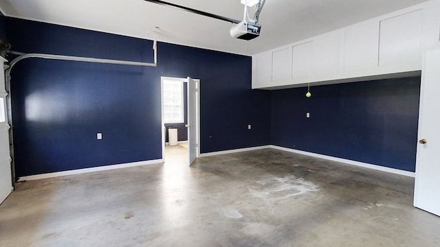 garage with a garage door opener and baseboards