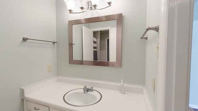 bathroom with an inviting chandelier and vanity