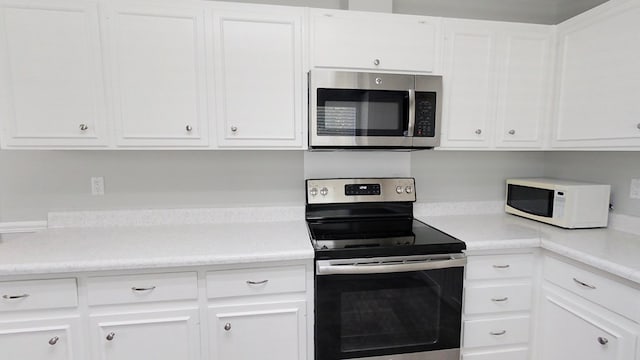 kitchen with white cabinets, stainless steel appliances, and light countertops