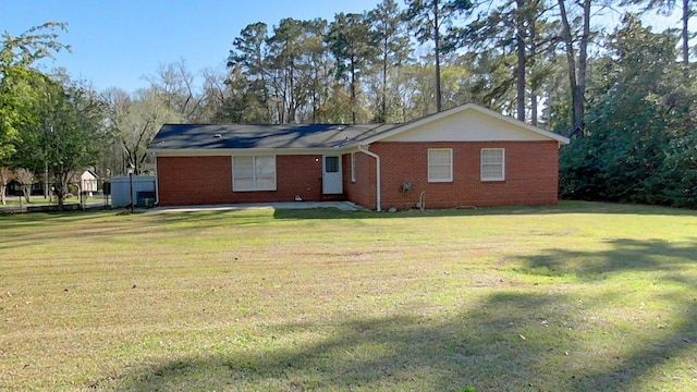 view of front facade featuring brick siding and a front yard