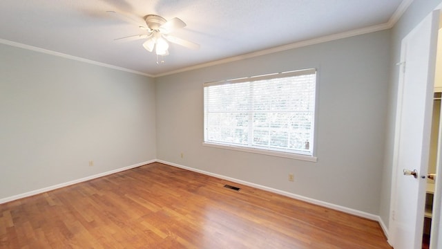 unfurnished room with visible vents, baseboards, wood finished floors, and a ceiling fan