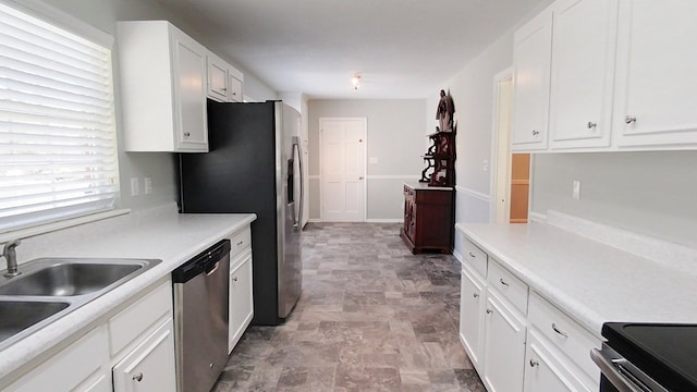 kitchen featuring a sink, stainless steel appliances, and white cabinetry