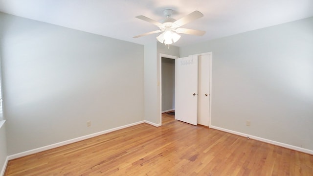 unfurnished room featuring baseboards, light wood-style floors, and ceiling fan