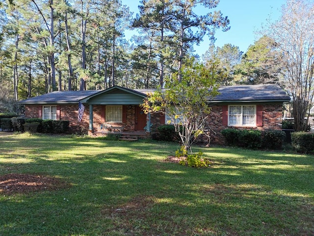 single story home with a front yard and covered porch