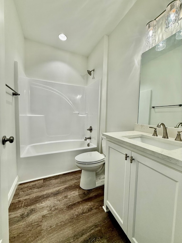 full bathroom with toilet, vanity, bathtub / shower combination, and hardwood / wood-style floors