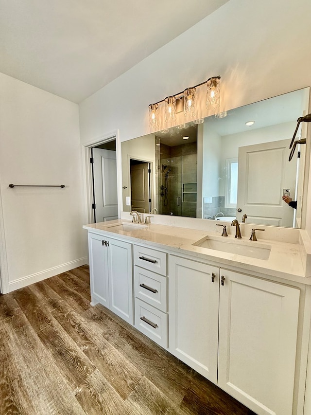 bathroom with vanity, wood-type flooring, and a shower with shower door