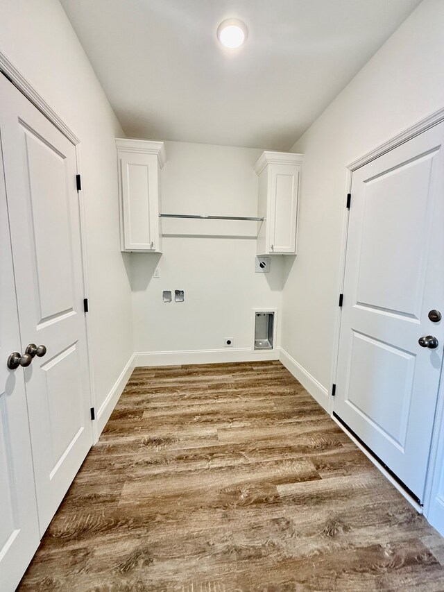 laundry area with hardwood / wood-style floors, cabinets, and hookup for an electric dryer