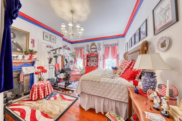 bedroom with crown molding, wood-type flooring, and a chandelier